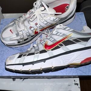 Nike White Sneakers with Red and Gold Accents